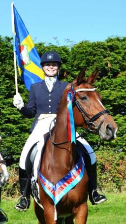 Charlie Hunt on Isaura Van't Ceusterhof holding the Pembrokeshire flag..jpg