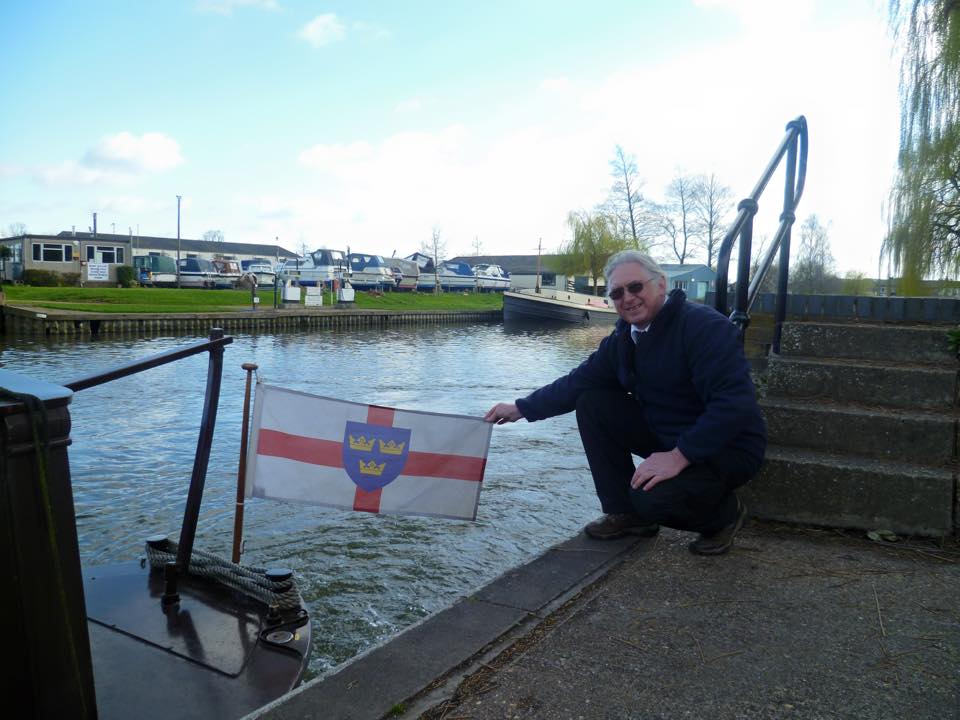 bob-owner-of-river-ely-cruising-vessel-the-liberty-bell-with-the-flag-of-east-anglia-which-he-flies-on-the-boat