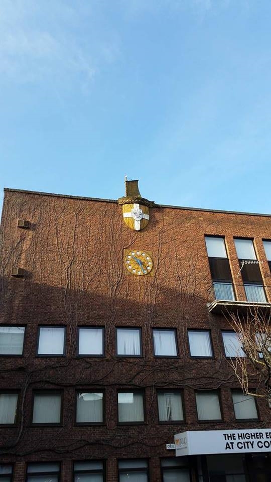 Norwich building with East Anglia flag as a shield.