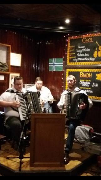 The South Uist flag at the Park Bar, Glasgow and held aloft by festival goers.